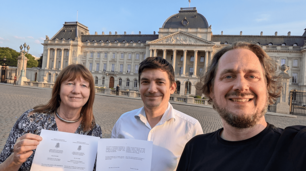 Gill Ferrell (1EdTech), Anthony Camilleri and Colin Tück (KIC) outside the Royal Palace of Brussels holding the founding documents of 1EdTech Europe.